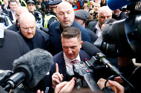 FILE PHOTO: Far right activist Stephen Yaxley-Lennon, who goes by the name Tommy Robinson, leaves the Old Bailey after his contempt of court charge was referred to the Attorney General, in London, Britain, October 23, 2018. REUTERS/Henry Nicholls/File Photo