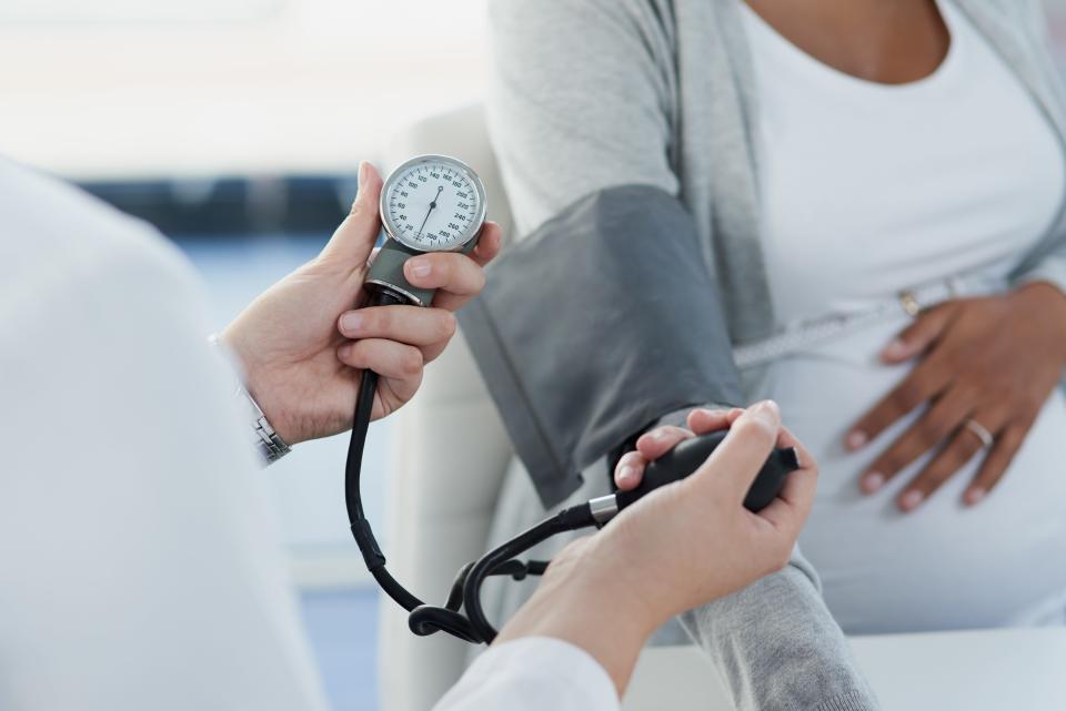 Doctor checking the blood pressure of a pregnant patient