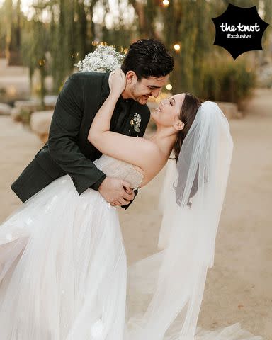 <p>Michelle Roller</p> Samantha Hanratty and Christian DeAnda embrace at their wedding.