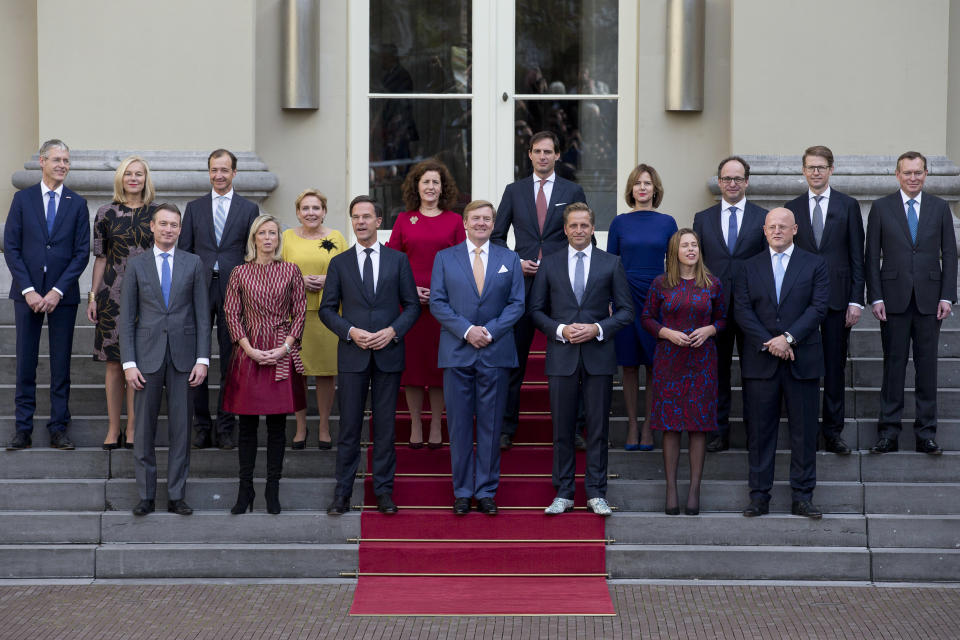 FILE- In this Thursday, Oct. 26, 2017, file photo, Prime Minister Mark Rute, center left, and Dutch King Willem-Alexander, center, pose with the ministers for the official photo of the new Dutch government on the steps of Royal Palace Noordeinde in The Hague, Netherlands. The Dutch Cabinet was meeting Friday Jan. 15, 2021, amid strong speculation that Prime Minister Mark Rutte's government will resign to take political responsibility for a scandal involving child benefit investigations.(AP Photo/Peter Dejong, File)