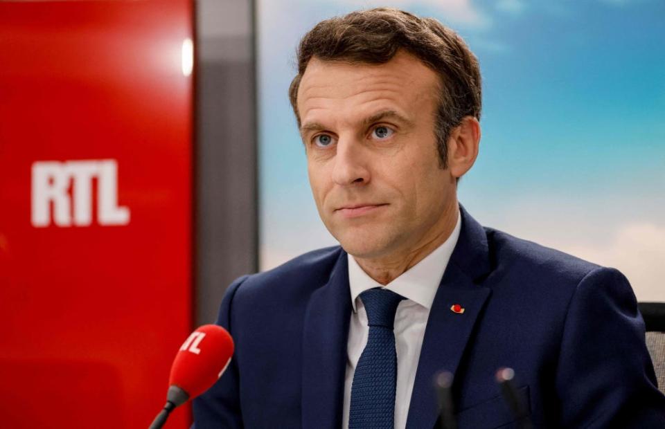 Macron poses before a live interview in the studio of French private radio station RTL in Neuilly-sur-Seine, 8 April 2022 (AFP via Getty)