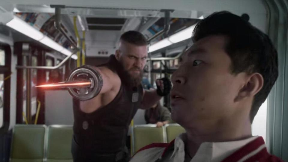 Razor Fist uses his shining red blade to attack Shang-Chi on a bus in San Francisco