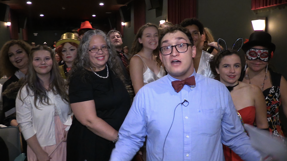 Capitol Arts Complex Assistant Director Jonathon Matwijec-Walda poses with audience members before a Rocky Horror screening.