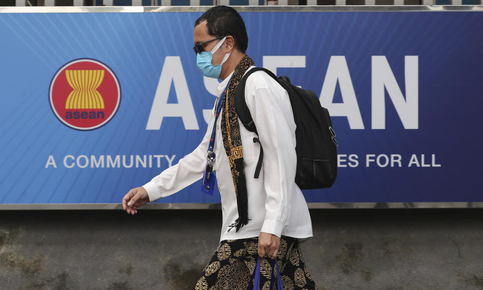 A man walks past the ASEAN Secretariat in Jakarta, Indonesia, Thursday, April 22, 2021. Leaders of the 10-member Association of Southeast Asian Nations meet Saturday, April 24, in Jakarta to consider plans to promote a peaceful resolution of the conflict that has wracked Myanmar since its military launched a deadly crackdown on opponents to its seizure of power in February. (AP Photo/Tatan Syuflana)