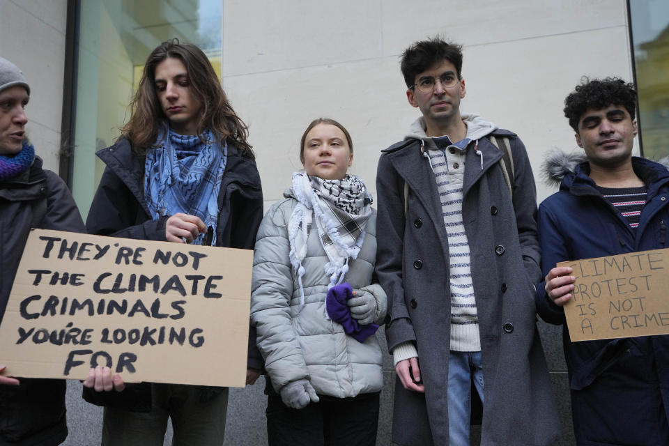 Environmental activist Greta Thunberg, centre, poses with other protesters for the media at Westminster Magistrates Court in London, Friday, Feb. 2, 2024. Climate activist Greta Thunberg is on trial for protesting outside a major oil and gas industry conference in London last year. (AP Photo/Kirsty Wigglesworth)