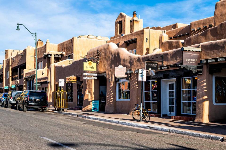 Old town street road in Santa Fe, New Mexico city with adobe style architecture