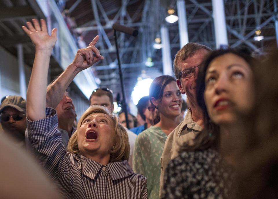 <p>Hillary Clinton looks up at crowds of supporters.</p>