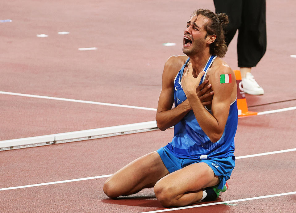 <p>Gianmarco Tamberi of Italy drops to his knees after earning gold in the Men's High Jump Final at Olympic Stadium on August 1.</p>