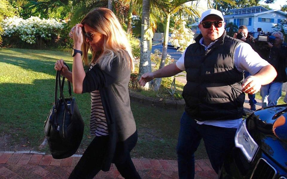 Mercedes Corby, sister of convicted Australian drug smuggler Schapelle Corby, is escorted by a personal security guard as she arrives at her mother's house  - Credit: Regi Verghese/Reuters