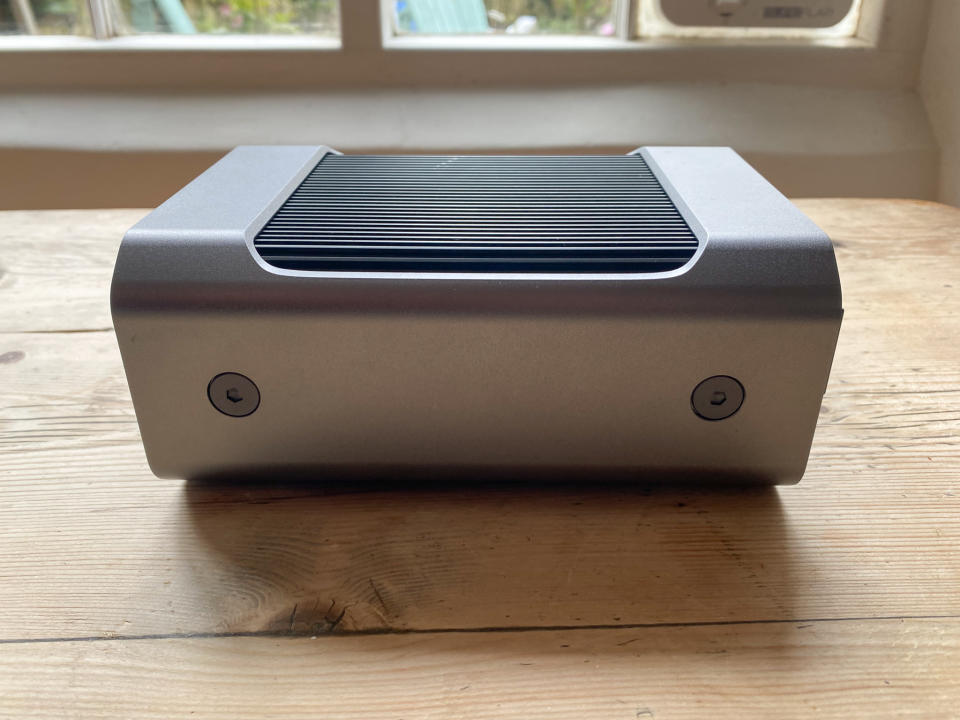 A SanDisk Professional Pro-Blade Station sitting on a wooden desk