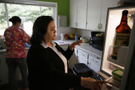 In this photo taken Thursday, Dec. 5, 2019, administrator Irais Lopez-Ortega opens a refrigerator while describing all the food that was lost in the recent power shuttoffs at the Cedars Care Home in Calistoga, Calif. Even before widespread blackouts hit California this fall, the utility that triggered them showed signs it wasn’t fully prepared. An Associated Press review reveals persistent problems during four smaller shutoffs that Pacific Gas & Electric did starting last year so power lines downed by strong winds wouldn’t spark wildfires. (AP Photo/Eric Risberg)