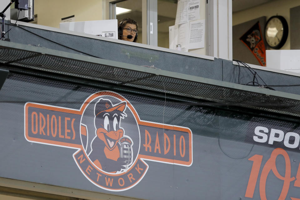 Baltimore Orioles broadcaster Melanie Newman is seen in the booth during the eighth inning of a baseball game between the Orioles and the Miami Marlins, Tuesday, Aug. 4, 2020, in Baltimore. With the broadcast, Newman became the first female broadcaster in Orioles franchise history to call play-by-play for a regular season game. (AP Photo/Julio Cortez)