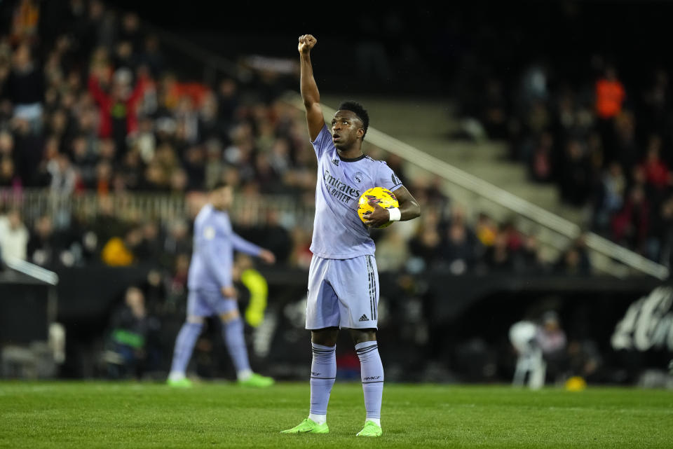 Real Madrid's Vinicius Junior celebrates after scoring his side's first goal during the La Liga soccer match between Valencia and Real Madrid at the Mestalla Stadium in Valencia, Spain, Saturday, March 2, 2024. (AP Photo/Jose Breton)