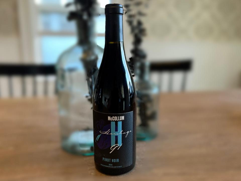 A bottle of McCollum Heritage 91 Pinot Noir sits on a table.
