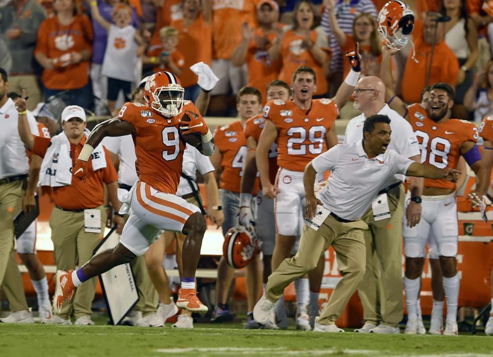 FILE - In this Aug. 29, 2019, file photo, Clemson's Travis Etienne runs down the sideline for a 90-yard touchdown during the first half of an NCAA college football game against Georgia Tech, in Clemson, S.C. Clemson is preseason No. 1 in The Associated Press Top 25, Monday, Aug. 24, 2020, a poll featuring nine Big Ten and Pac-12 teams that gives a glimpse at what’s already been taken from an uncertain college football fall by the pandemic. (AP Photo/Richard Shiro, File)