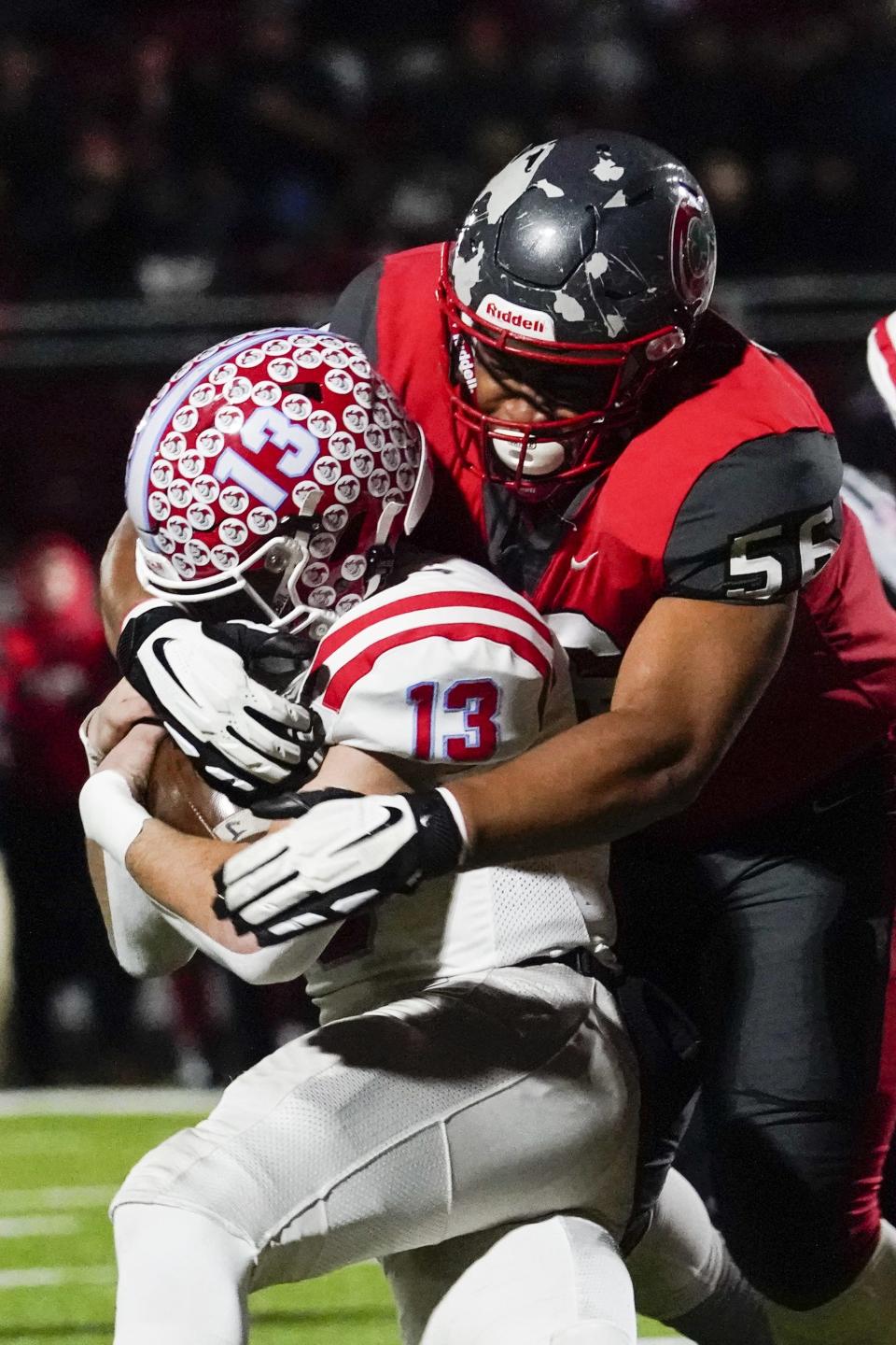 Toledo Central Catholic defensive end Ronald Collins tackles Kings quarterback Will Kocher during the first quarter of a state semifinal, last Friday in Wapakoneta.