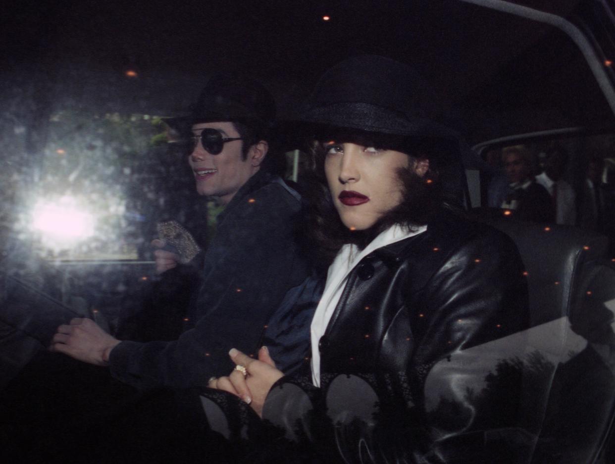 US pop star Michael Jackson and Lisa-Marie Presley leave a hotel at Euro Disneyland, Paris on Sept. 5, 1994. (AP Photo)