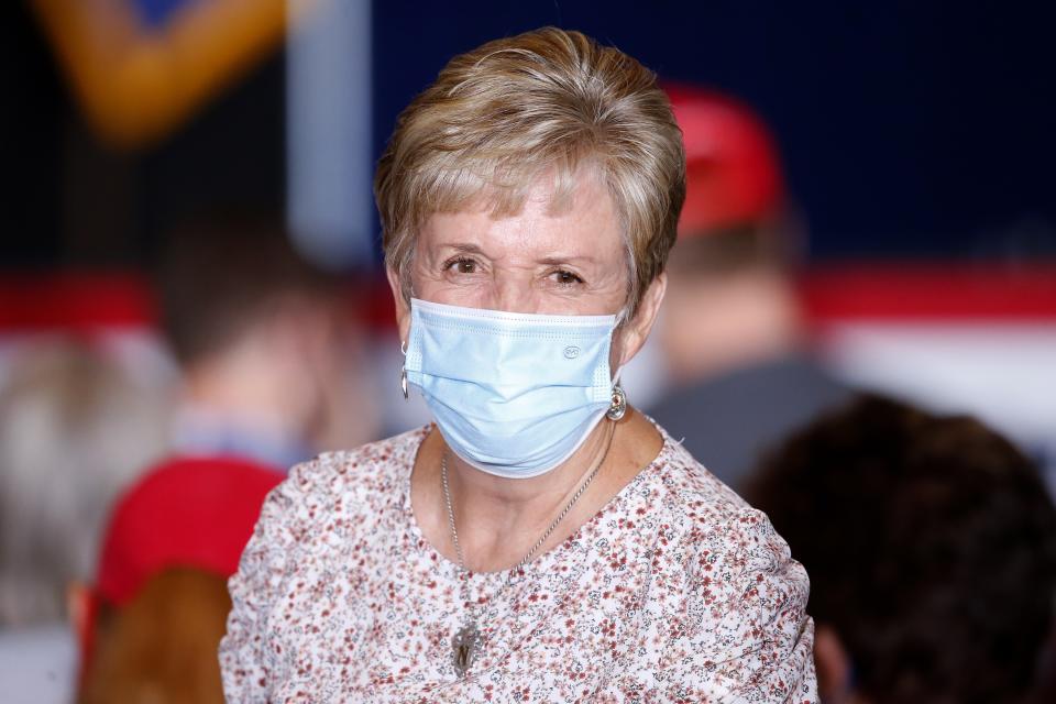 In this Aug. 11, 2020, photo Norma Hastings, a 71-year-old Church of Jesus Christ of Latter-day Saints member from Gilbert, waits for Vice President Mike Pence to speak at the "Latter-Day Saints for Trump" Coalition launch event in Mesa, Ariz. Hastings said she thinks Pence "keeps Trump on the right road." (AP Photo/Ross D. Franklin)