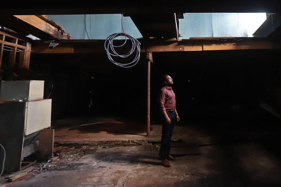 Curtis Doucette, Jr. looks up at part of the ceiling in the music room that had fallen in at the historic hotel and nightclub The Dew Drop Inn on LaSalle Street in Central City. Photographed on Friday, July 23, 2021 in New Orleans, LA.