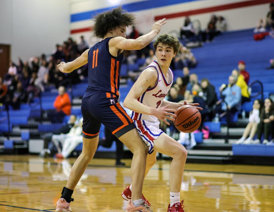 Leander point guard Ryder Bradley looks to drive toward the basket against Glenn's Kristofer Benson during the Lions' 44-34 win Friday night at Glenn High School. With only a couple of District 25-5A games remaining, every win is an important one in the district's jumbled playoff race.