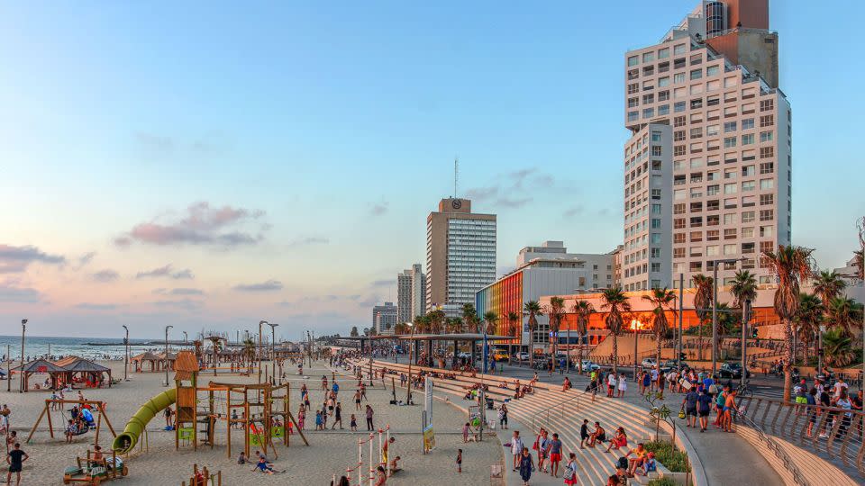 As the sun sets at the famous Tel Aviv beachfront in Israel, young people's thoughts may turn to coming nightlife options. - Bogdan Lazar/Alamy Stock Photo