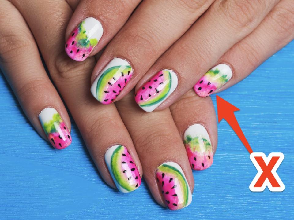 "X" over image of manicure with watermelon design.