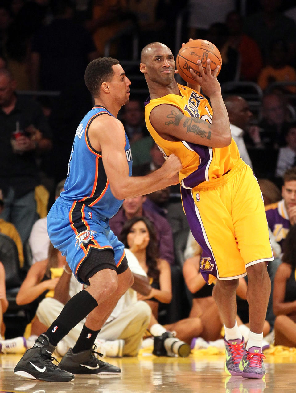 Lakers guard Kobe Bryant, right, posts up Oklahoma City's Thabo Sefolosha on May 19 in Los Angeles. (Photo by Stephen Dunn/Getty Images)