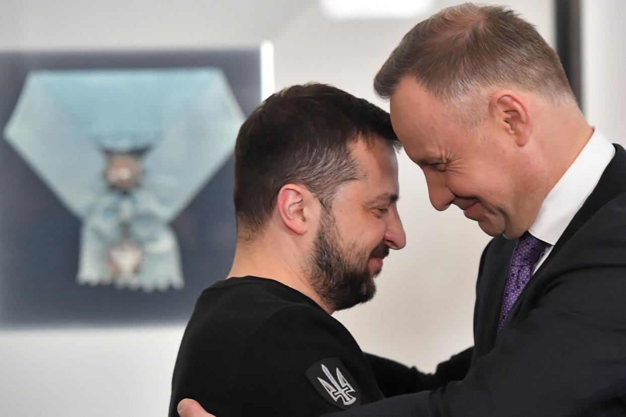 Polish President Andrzej Duda (R) awards Ukrainian President Volodymyr Zelensky with Order of the White Eagle during his visit in Warsaw, Poland (EPA)