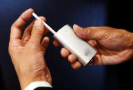 A staff of British American Tobacco Japan inserts a tobacco into its new tobacco heating system device 'glo' during a demonstration after a news conference in Tokyo, Japan, November 8, 2016. REUTERS/Kim Kyung-Hoon