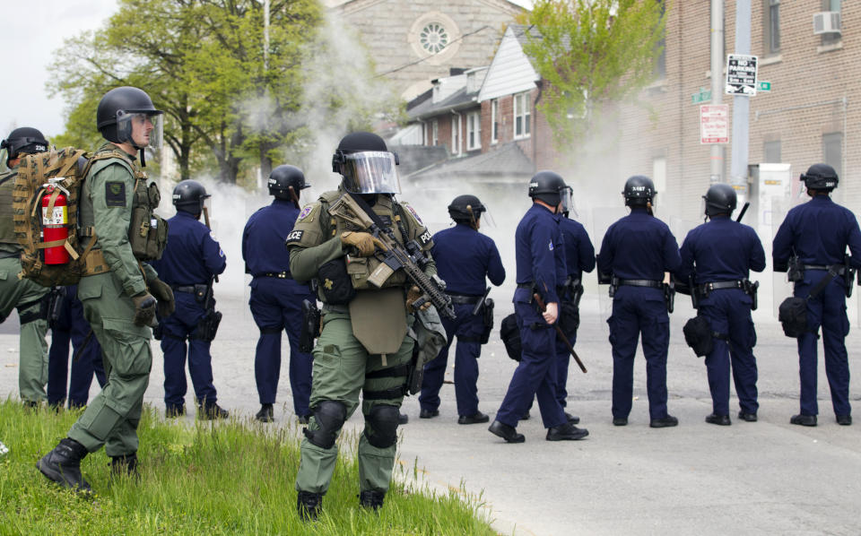 Baltimore police officers respond to demonstrators after the funeral of Freddie Gray, Monday, April 27, 2015, in Baltimore. (AP Photo/Jose Luis Magana)