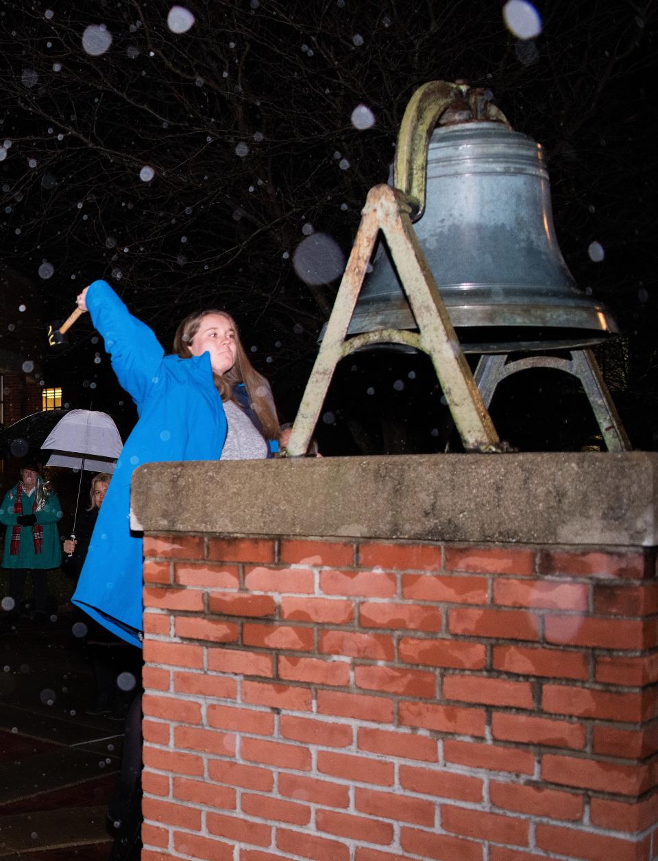 Kayley Craig, a secondary mathematics Adrian College student, and a Morenci resident, readies to strike the Victory Bel at Adrian College, Nov. 16, 2022, during the college's ceremony recognizing 10 teacher education students who passed the State of Michigan MTTC test, also known as the Michigan Tests for Teacher Certification.