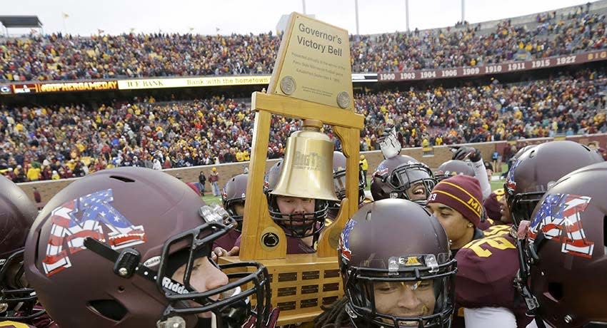 Minnesota Players carry the Governor's Victory Bell trophy after defeating Penn State 24-10 in an NCAA college football game in Minneapolis Saturday, Nov. 9, 2013.