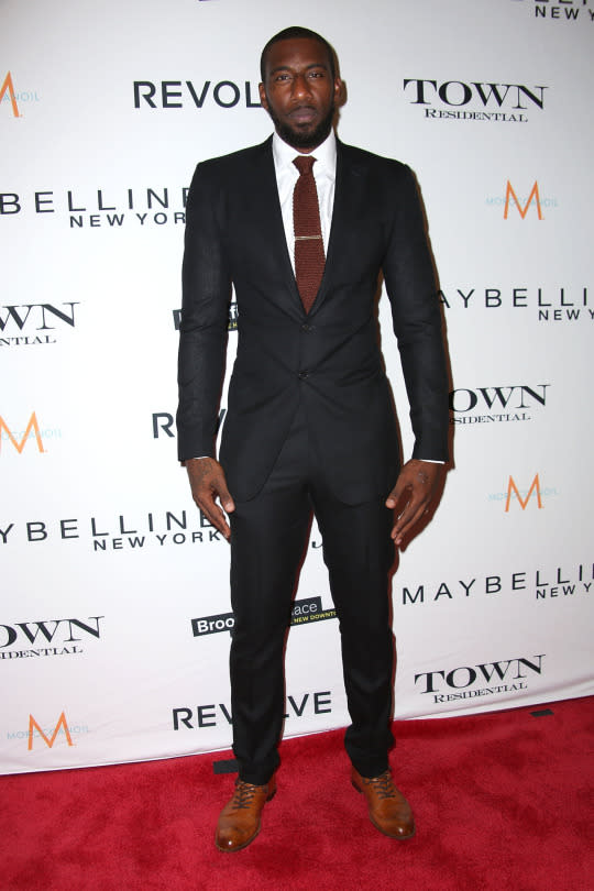 <p>The Miami Heat player was a class act in a black suit, tailored expertly to his towering 6’11’ frame. The fashion forward athlete accented the look with faded leather shoes and a textured knit burgundy tie.<br></p>