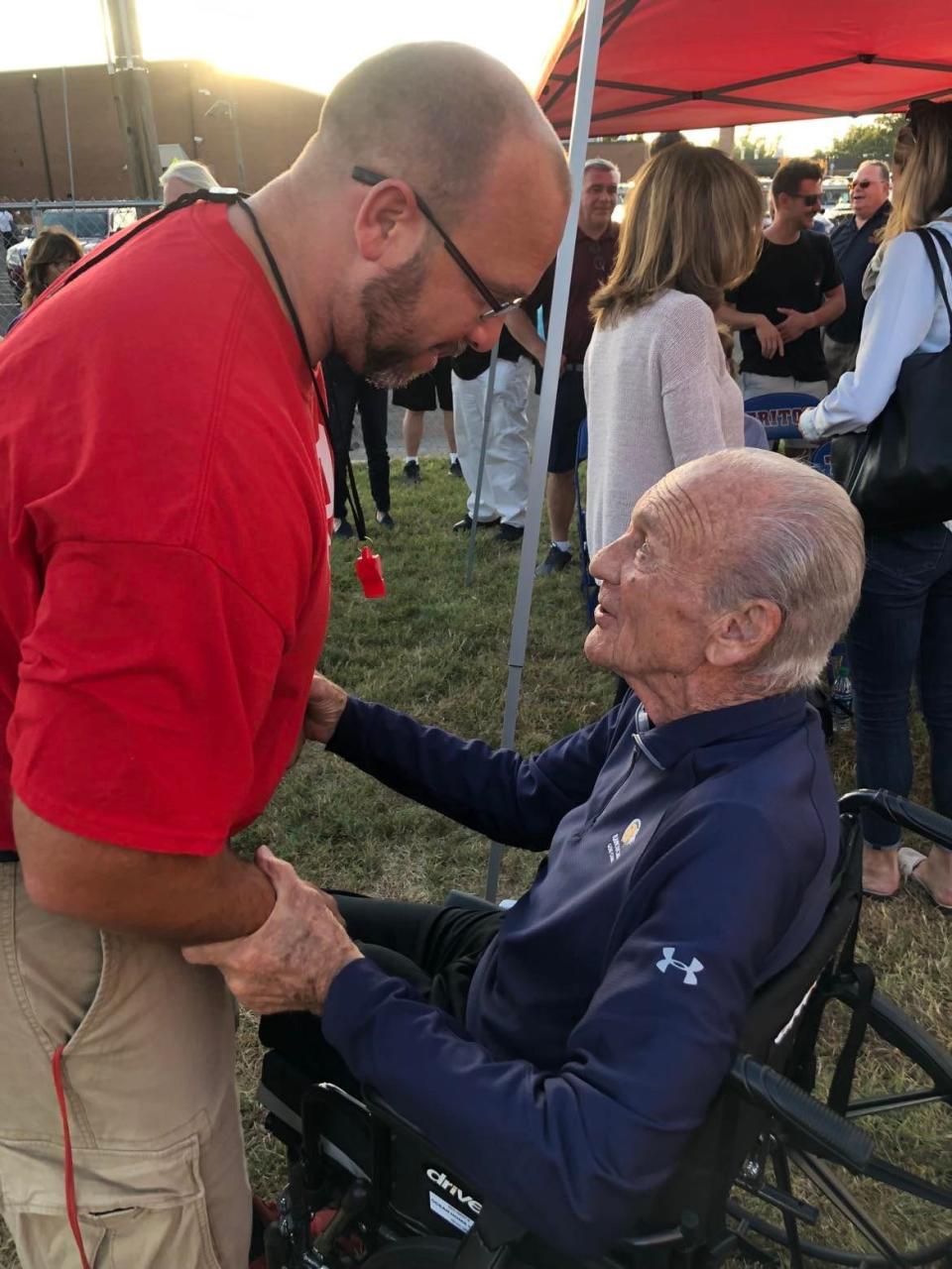 Former Triton football coach Jim Doyle (right) talks with current head coach Domenic Tomeo during a ceremony honoring Doyle at the school. Doyle passed away on Thursday. He was 93.