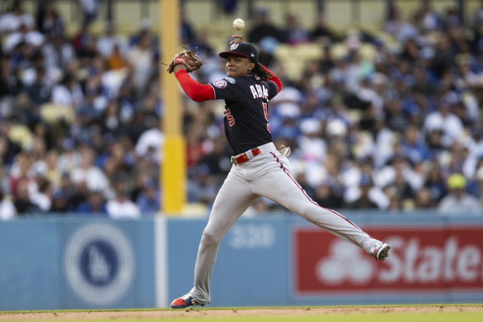 Washington Nationals shortstop CJ Abrams (5) loses control of the ball on a throw during the second inning of a baseball game against the Los Angeles Dodgers in Los Angeles, Monday, May 29, 2023. (AP Photo/Kyusung Gong)