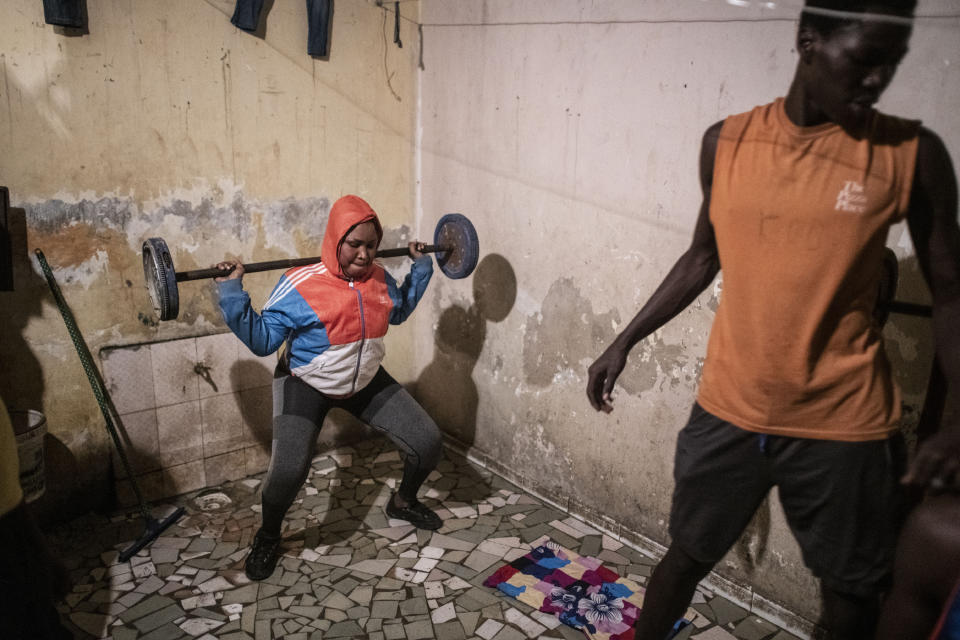 The family of Bara Tambedou exercises at home after breaking the fast on the first day of the Muslim holy month of Ramadan, in Dakar, Senegal, April 25, 2020. This year the family is celebrating Ramadan at home, with prohibitions on public gatherings and a dusk-to-dawn curfew in place to curb the spread of the coronavirus. (AP Photo/Sylvain Cherkaoui)