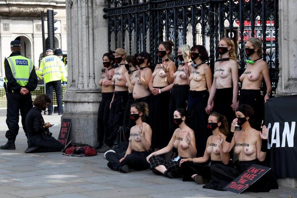 LONDON, UNITED KINGDOM - SEPTEMBER 10: (EDITORS NOTE: Image contains nudity) A group of topless women with body paint on their chests, who padlockled themselves to the gates of Parliament, hold a banner that reads "Cant Bare The Truth ?" as they protest at the consequences of a 4 degree global rise in temperature by 2100 on September 10, 2020 in London, England. Extinction Rebellion Activists are holding ten days of climate action across the UK. Their activities began on September 1st. (Photo by Chris Ratcliffe/Getty Images)