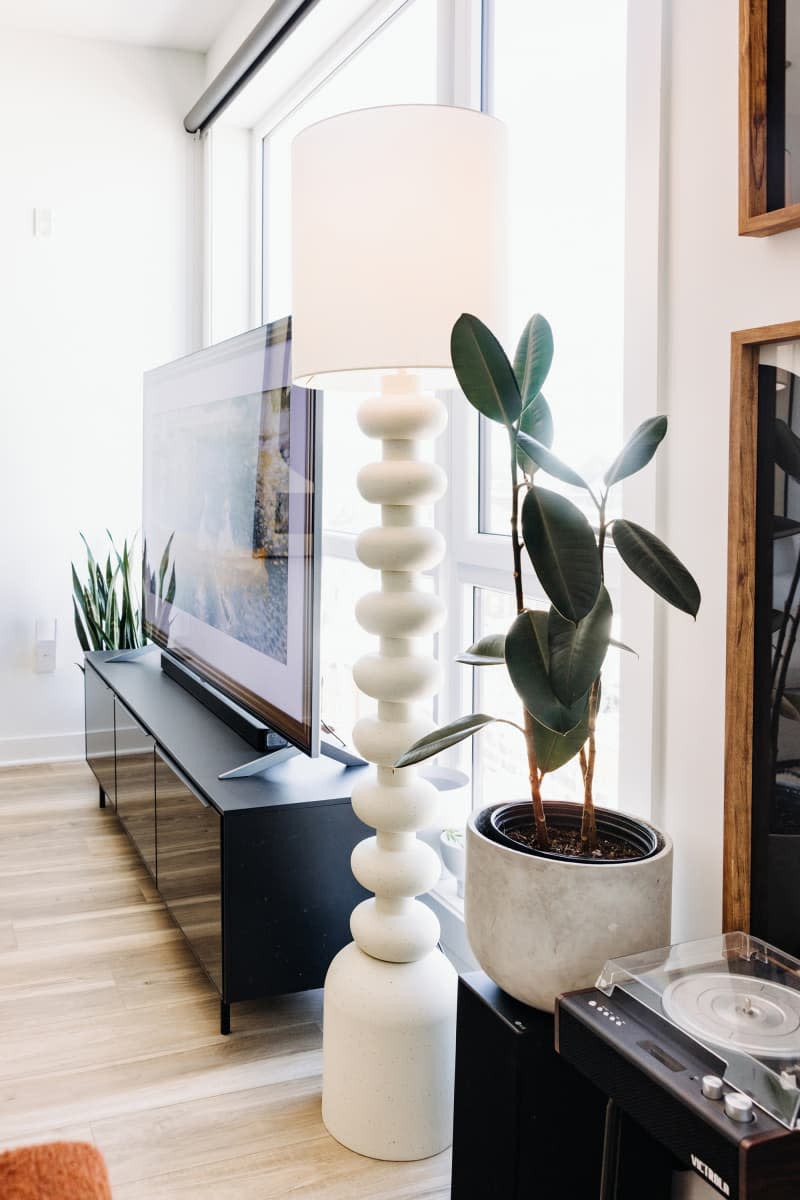 Detail of curvy modern white floor lamp in living room