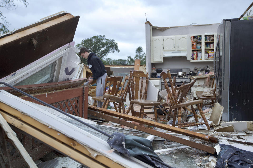 Nathan Casey, 16, surveys the damage of his home after a tornado swept through the area in Woodridge, Ill., Monday June 21, 2021. (Vashon Jordan Jr./Chicago Tribune via AP)