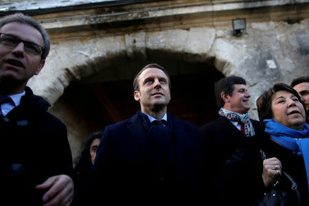 FILE PHOTO: Emmanuel Macron (C), head of the political movement En Marche !, or Onwards !, and candidate for the 2017 presidential election, visits a farm as part of his presidential campaign in Montlouis-sur-Loire near Tours, France, February 10, 2017. At R, Corinne Lepage, Founder of Cap21. REUTERS/Stephane Mahe/File Photo