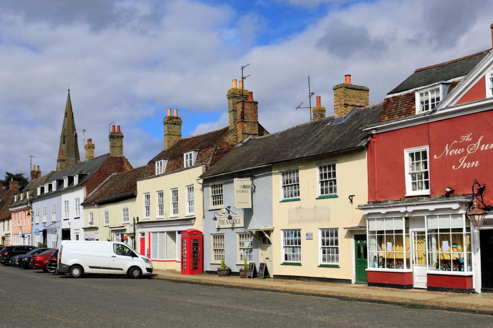 Colourful shops on the High Street, Kimbolton village, Cambridgeshire; England, UK