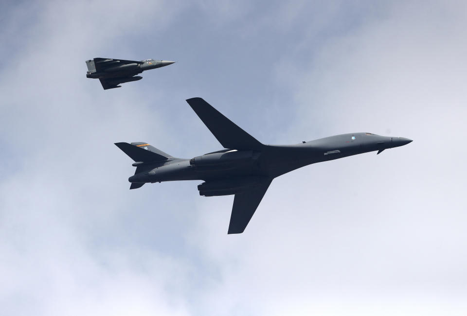 A U.S. Air Force B-1B Lancer bomber, right, flies with an Indian Air Force light combat aircraft Tejas on the inaugural day of Aero India 2021 at Yelahanka air base in Bengaluru, India, Wednesday, Feb. 3, 2021. India has high hopes its ties with the United States will deepen under President Joe Biden, who was a key proponent of the 2008 civil nuclear deal between the countries and whose new administration includes several Indian Americans. (AP Photo/Aijaz Rahi)