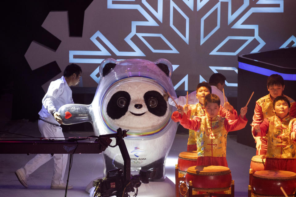 Workers push out the Beijing 2022 Winter Olympic Mascot Bing Dwen Dwen during a ceremony held at the Shougang Ice Hockey Arena in Beijing on Tuesday, Sept. 17, 2019. (AP Photo/Ng Han Guan)