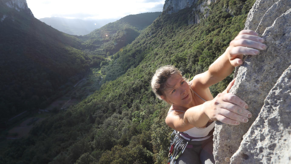 rock climbing terms: climber clings to generous holds