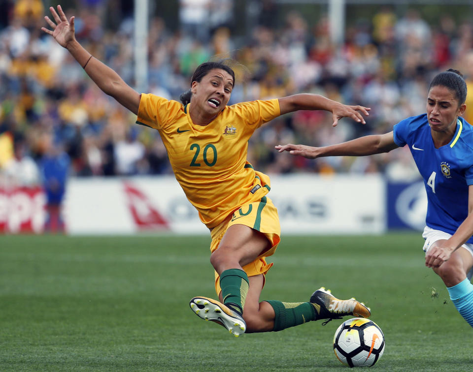 FILE - In this Sept. 16, 2017, file photo, Australia's Sam Kerr, left, fights for the ball against Brazil's Rafaelle Carvalho Souzav during their friendly soccer match in Penrith, Australia. Kerr has been named captain of the women's national soccer, Wednesday, Feb. 27, 2019, as they prepared for Thursday's first match against New Zealand in the four-team Cup of Nations tournament. (AP Photo/Daniel Munoz, File)