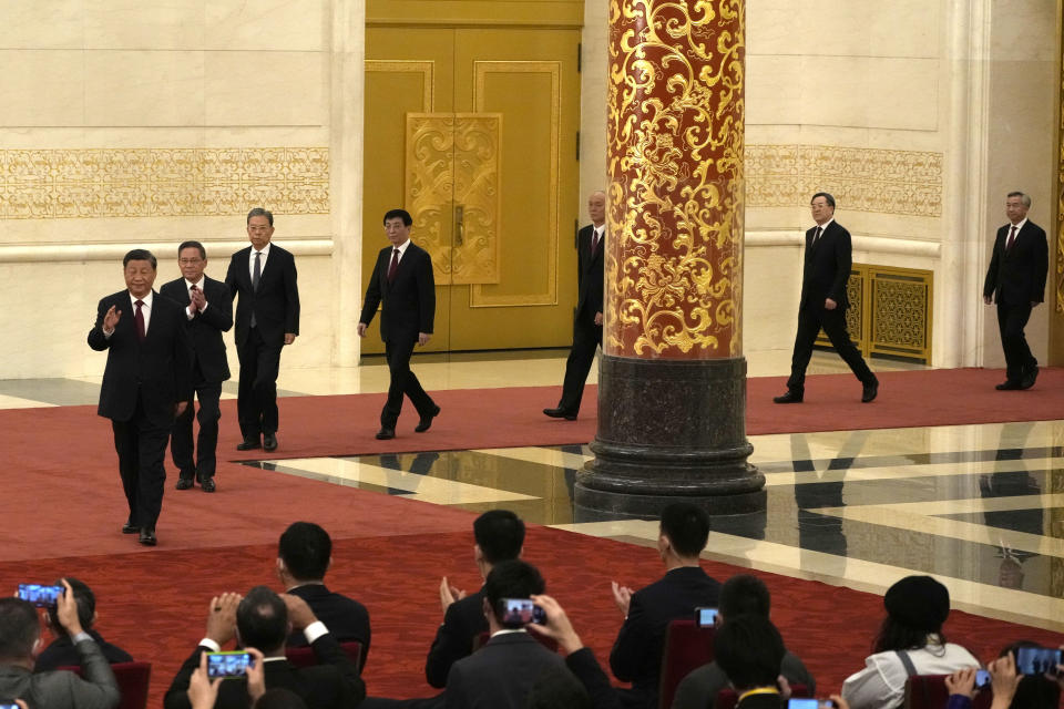 New members of the Politburo Standing Committee, from left, President Xi Jinping, Li Qiang, Zhao Leji, Wang Huning, Cai Qi, Ding Xuexiang, and Li Xi arrive at the Great Hall of the People in Beijing, Sunday, Oct. 23, 2022. (AP Photo/Andy Wong)