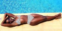 <p>Lupita shows her stripes by a sparkling pool in Bali, aka not your typical office.</p>