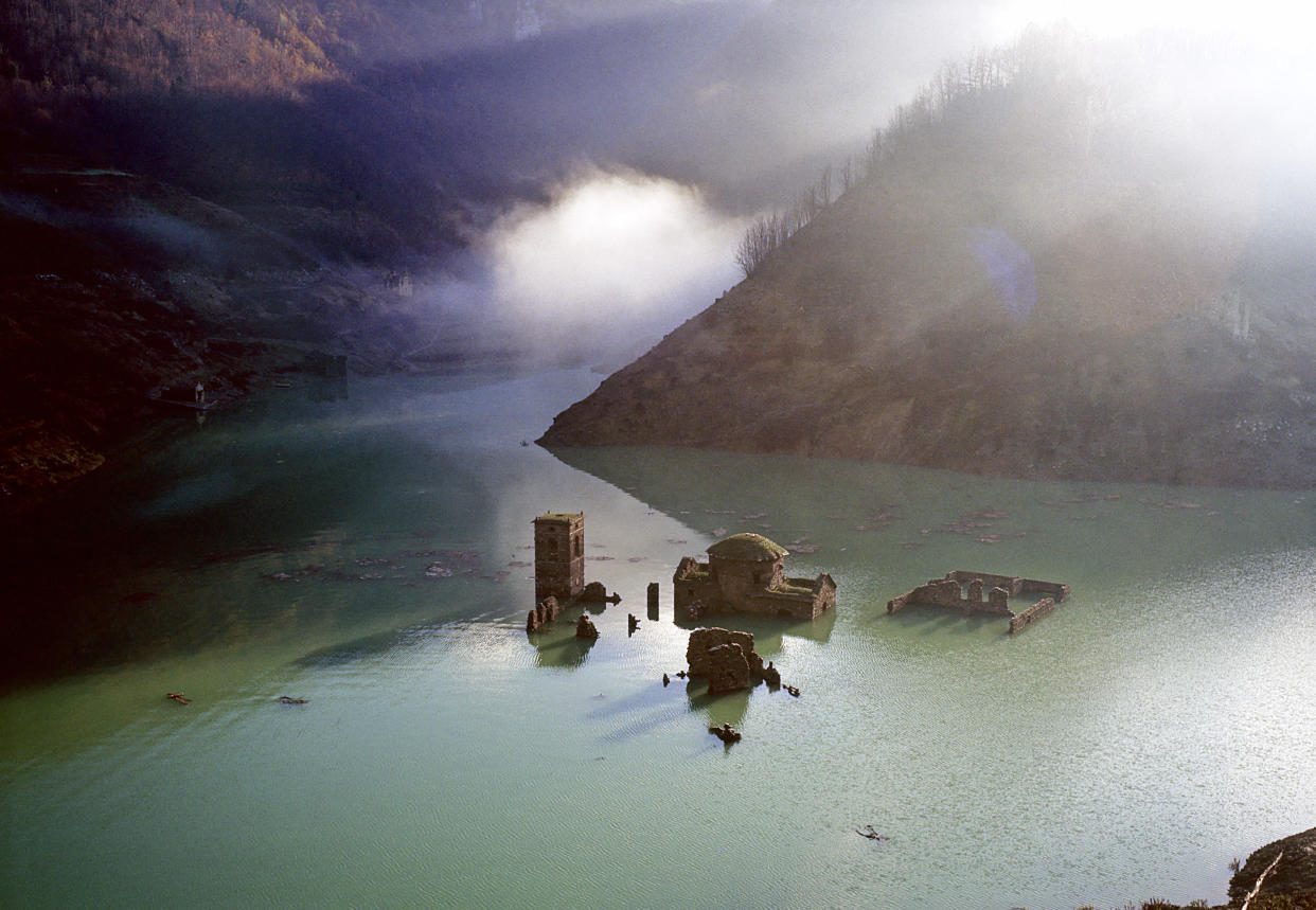 Italy, the village of Fabbriche di Careggine, at the foothills of the Apuan Alps (Tuscany), lays completely submerged by water as a dam was built next to it. But every decade, for maintenance reasons, the basin, now called Lake Vagli, must be drained and the village reappears like a ghost. (Photo by Romano Cagnoni/Getty Images)