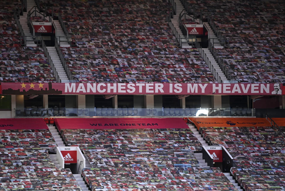 Empty stands are covered with photos of supporters ahead of the English FA Cup 4th round soccer match between Manchester United and Liverpool at Old Trafford in Manchester, England, Sunday, Jan. 24, 2021. (Laurence Griffiths/Pool via AP)