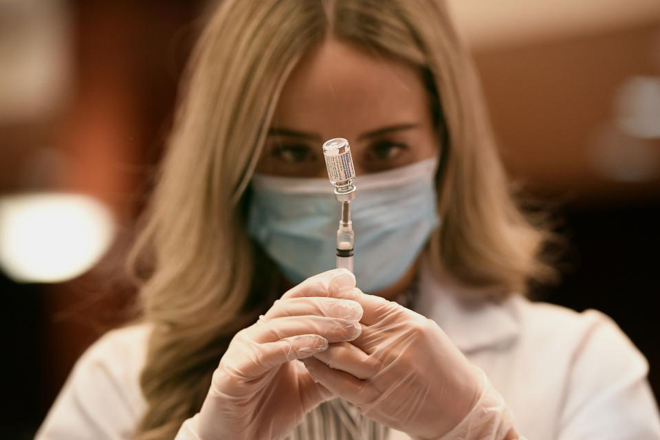 FILE - In this March 3, 2021, file photo, pharmacist Madeline Acquilano draws a syringe of Johnson & Johnson COVID-19 at Hartford Hospital in Hartford, Conn. Despite the clamor to speed up the U.S. vaccination drive against COVID-19 and get the country back to normal, the first three months of the rollout suggest faster is not necessarily better. (AP Photo/Jessica Hill, File)